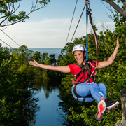 A happy guest on the zipline at Lake Erie Canopy Tours
